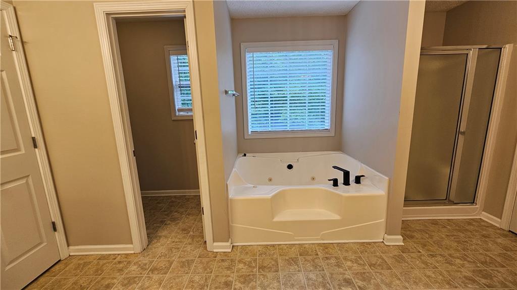 147 Oliver Drive Dallas, GA 30132 - Photo 27 of 55 a bathroom with a bathtub and shower