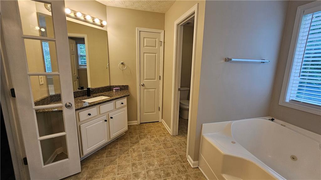 147 Oliver Drive Dallas, GA 30132 - Photo 29 of 55 a spacious bathroom with a tub sink and mirror
