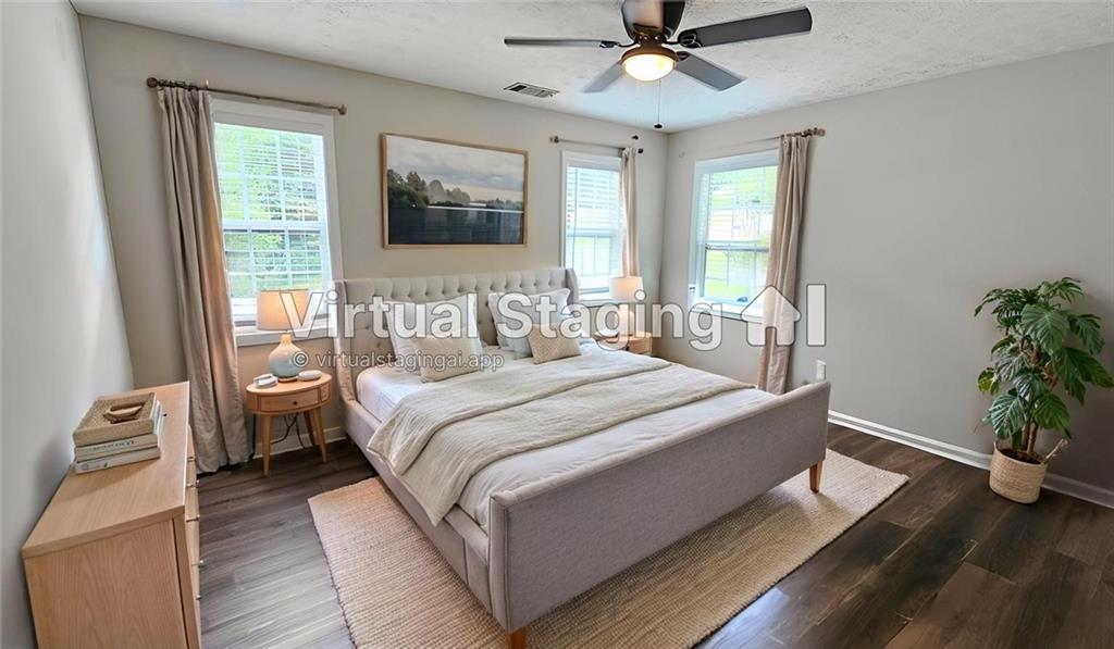 147 Oliver Drive Dallas, GA 30132 - Photo 37 of 55 a bedroom with a large bed and a potted plant
