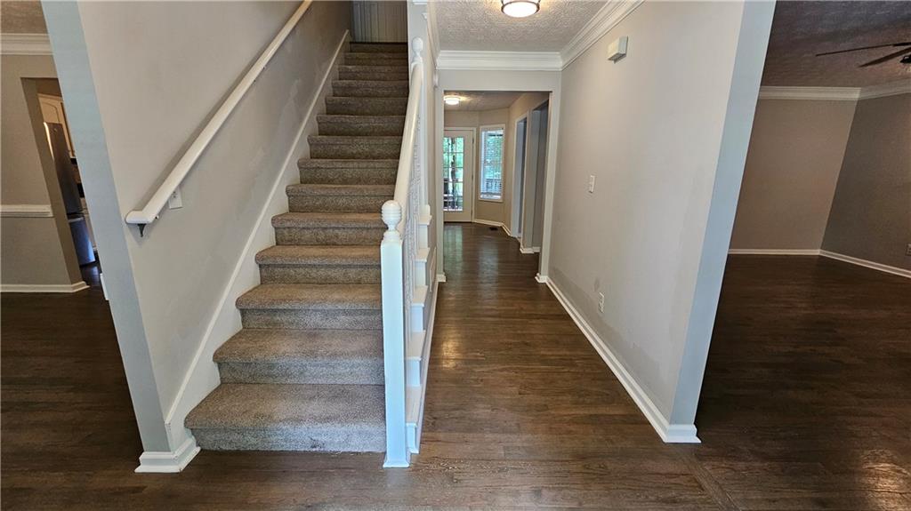 147 Oliver Drive Dallas, GA 30132 - Photo 6 of 55 a view of staircase with wooden floor and white walls