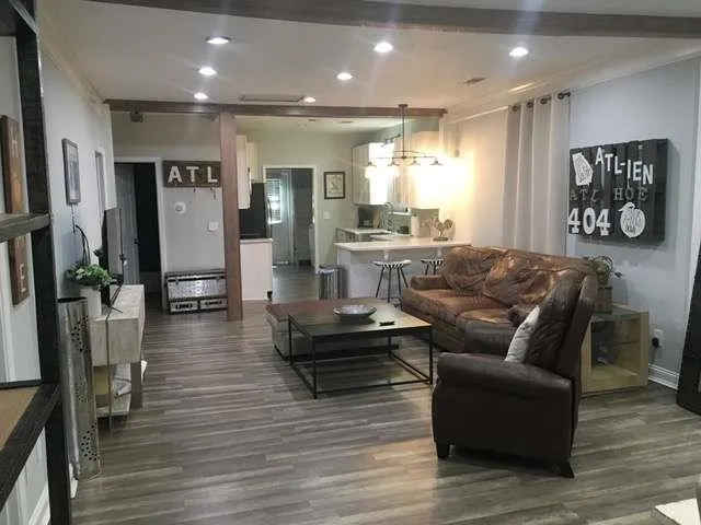 a living room with furniture and wooden floor