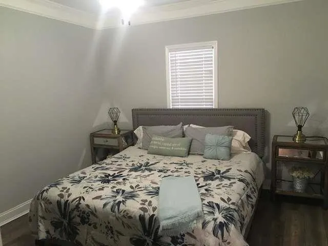 a bed sitting in a bedroom next to a window