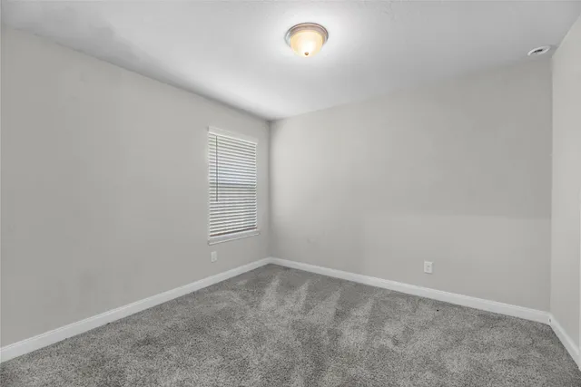 an empty room with a empty space and window