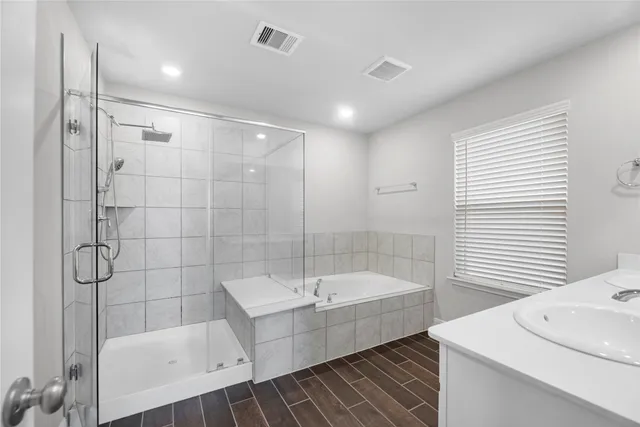 a bathroom with a bathtub and a shower