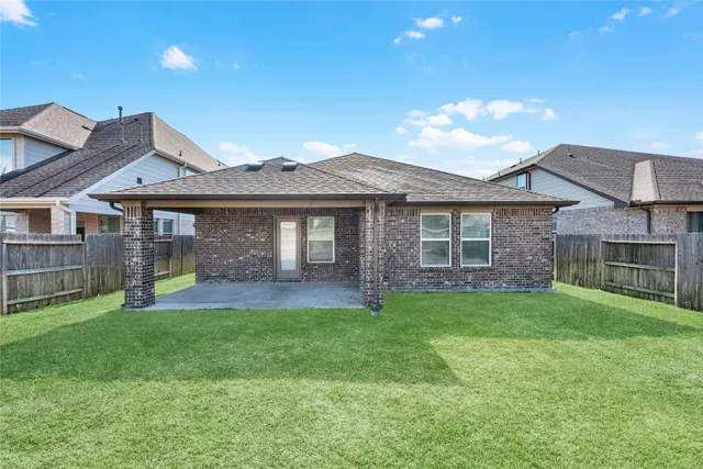 a view of a yard in front of a house with large trees