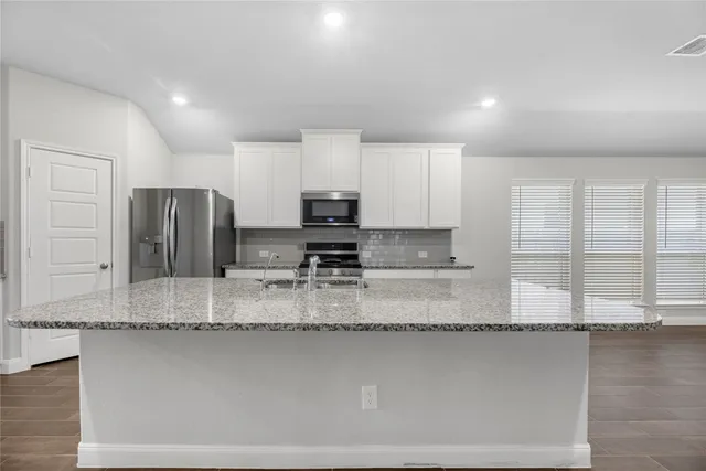 a large bathroom with double vanity and a granite counter tops