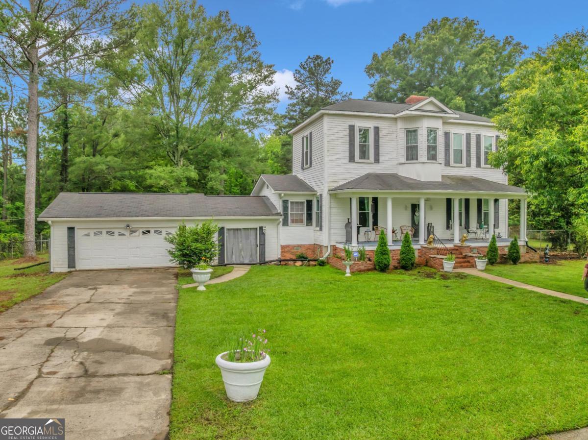 a view of a house with backyard sitting area and garden