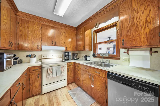 a kitchen with a sink stove and cabinets