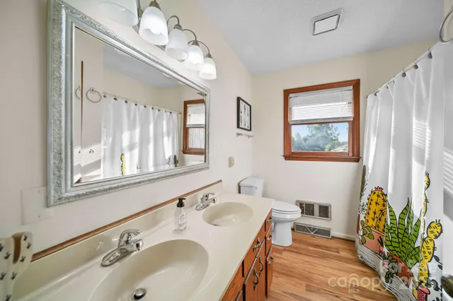 a bathroom with a sink double vanity and a mirror