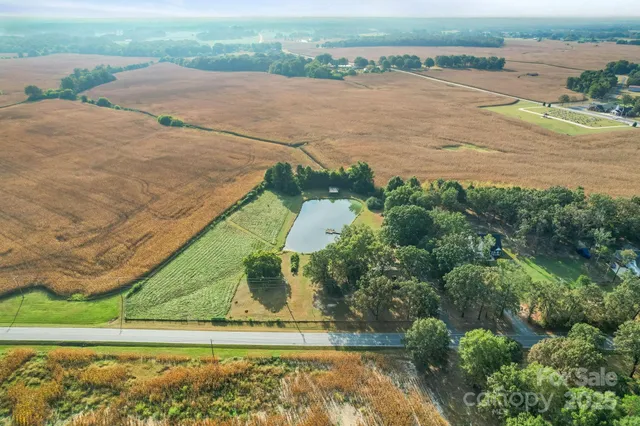 an aerial view of a houses with outdoor space and ocean view
