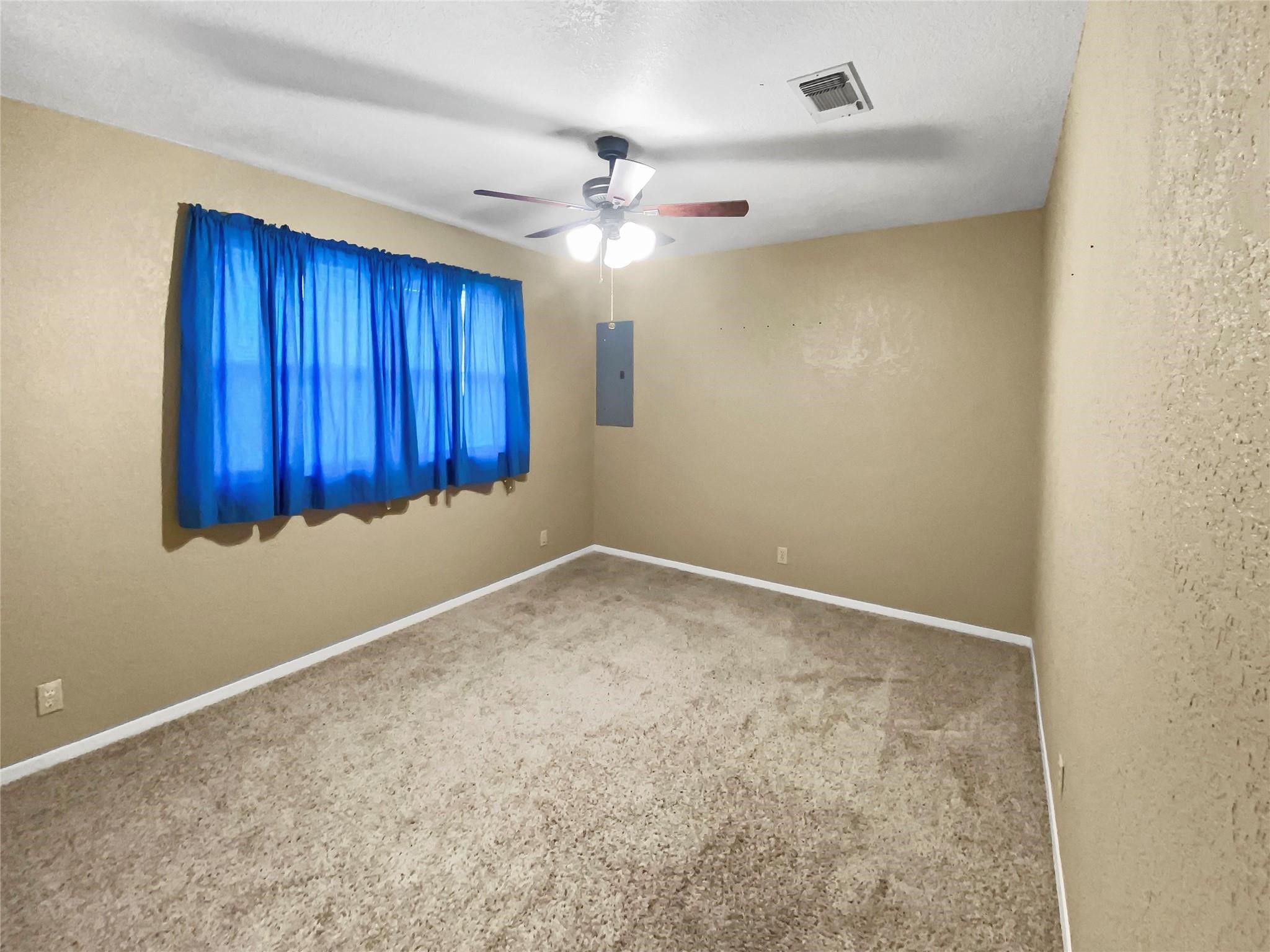 516 Dwyer Street Angleton, TX 77515 - Photo 13 of 18 an empty room with a ceiling fan and a window