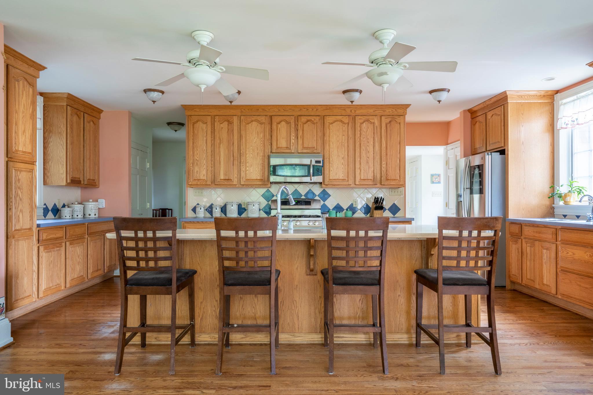 301 Midland Avenue Wayne, PA 19087 - Photo 14 of 63 a kitchen with granite countertop a dining table chairs and white cabinets