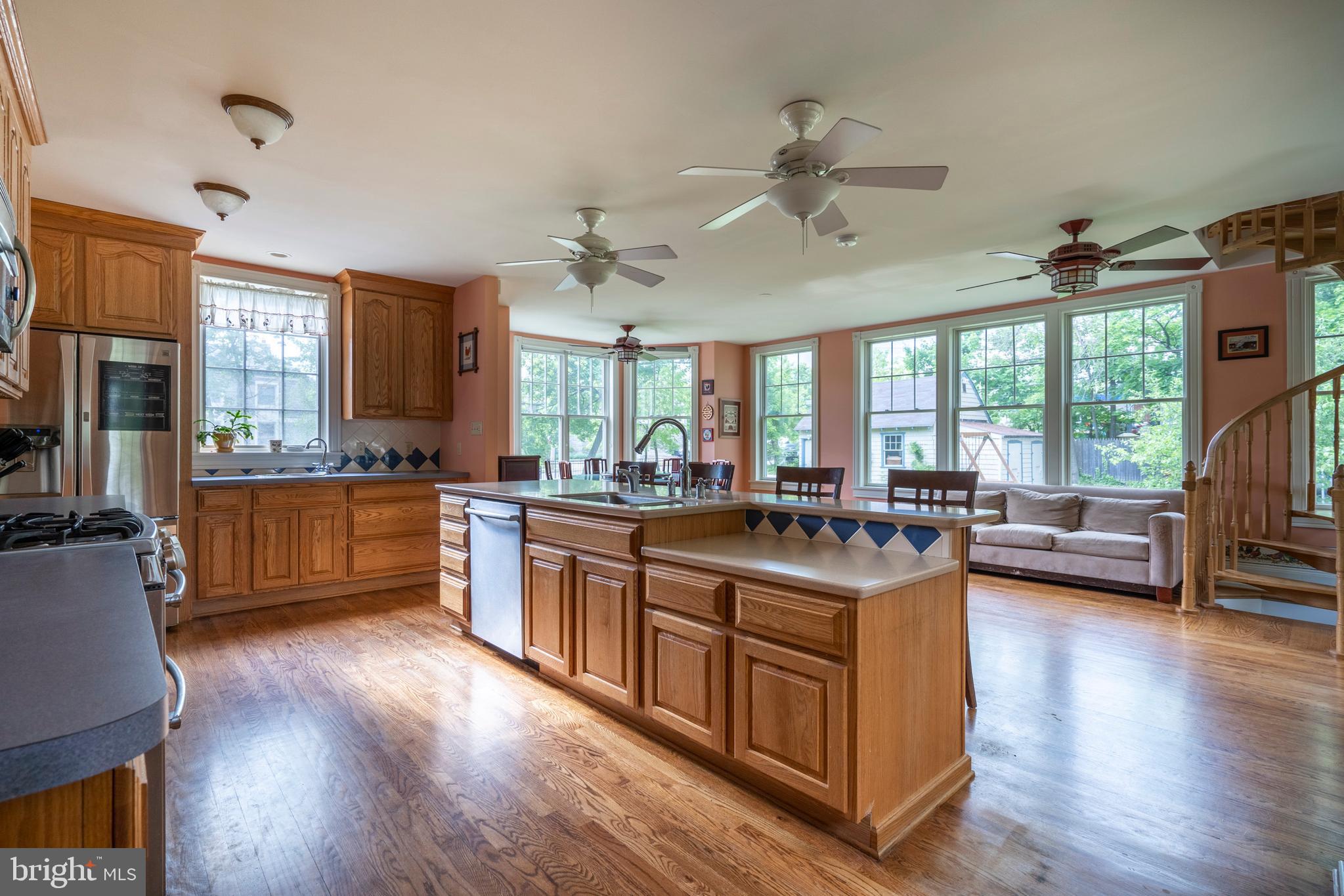 301 Midland Avenue Wayne, PA 19087 - Photo 19 of 63 a kitchen with stainless steel appliances granite countertop wooden floors and white cabinets