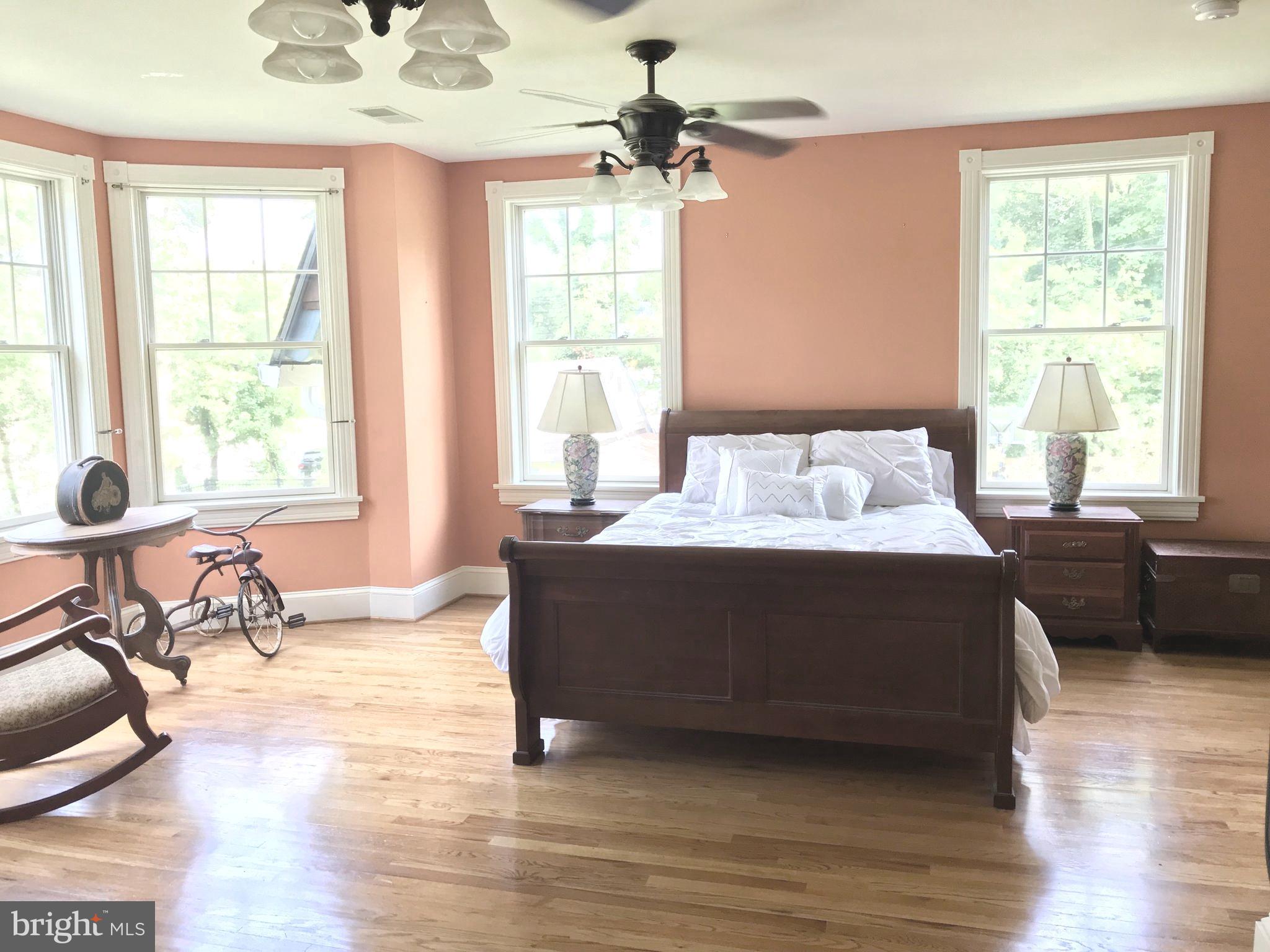 301 Midland Avenue Wayne, PA 19087 - Photo 24 of 63 a bedroom with a bed a chandelier and a window