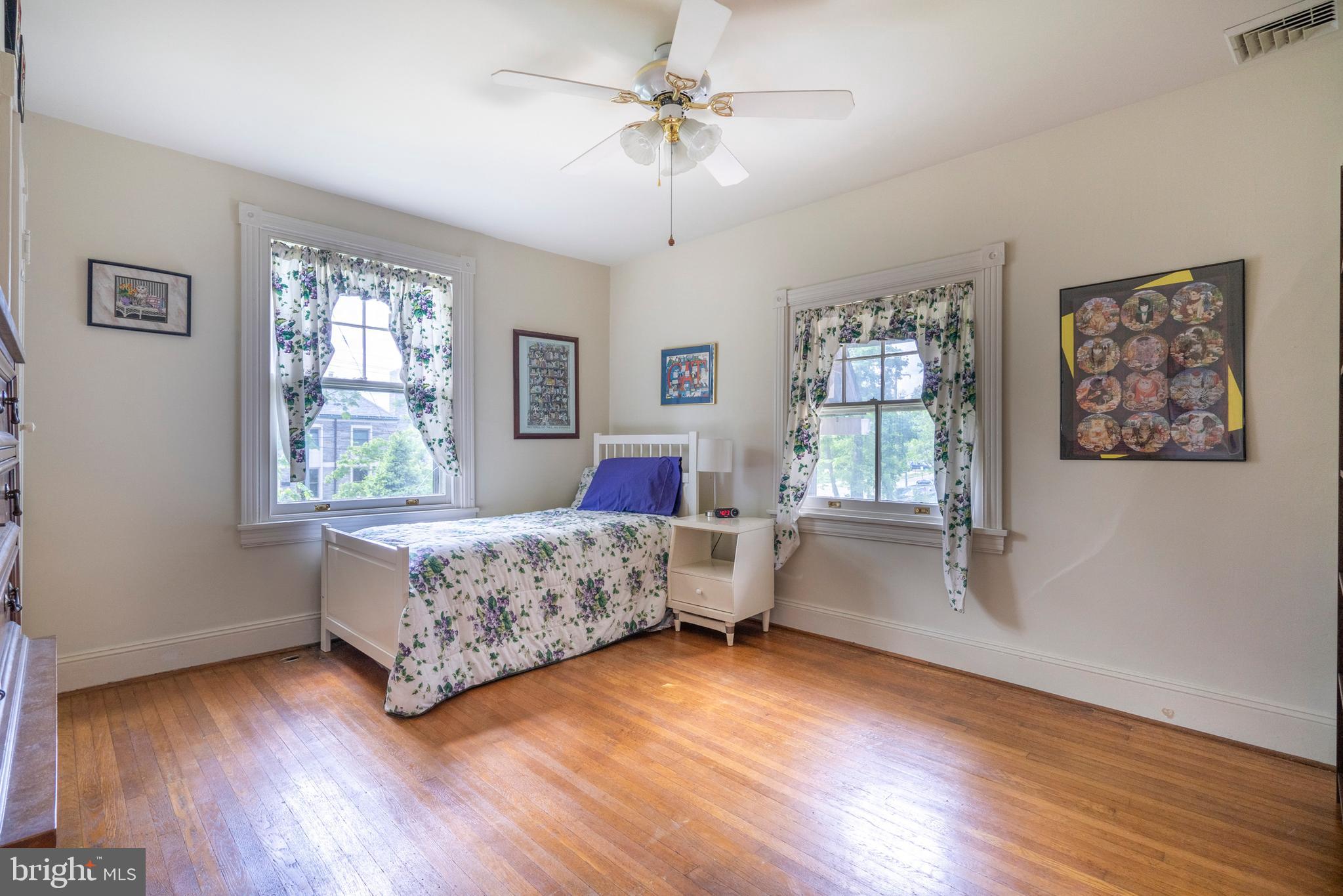 301 Midland Avenue Wayne, PA 19087 - Photo 31 of 63 a bedroom with a large bed chandelier and a window