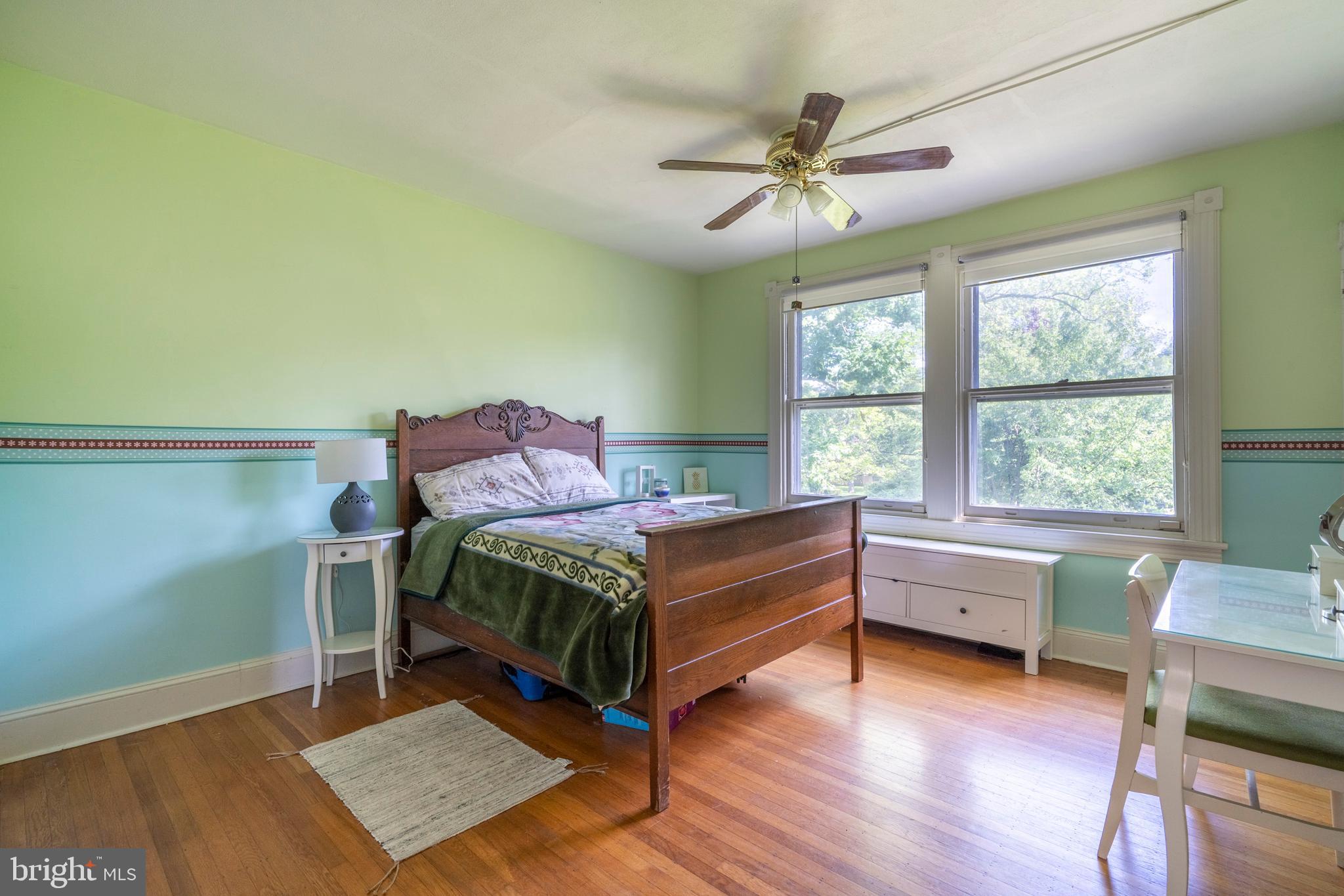 301 Midland Avenue Wayne, PA 19087 - Photo 32 of 63 a bedroom with a bed and a table in it
