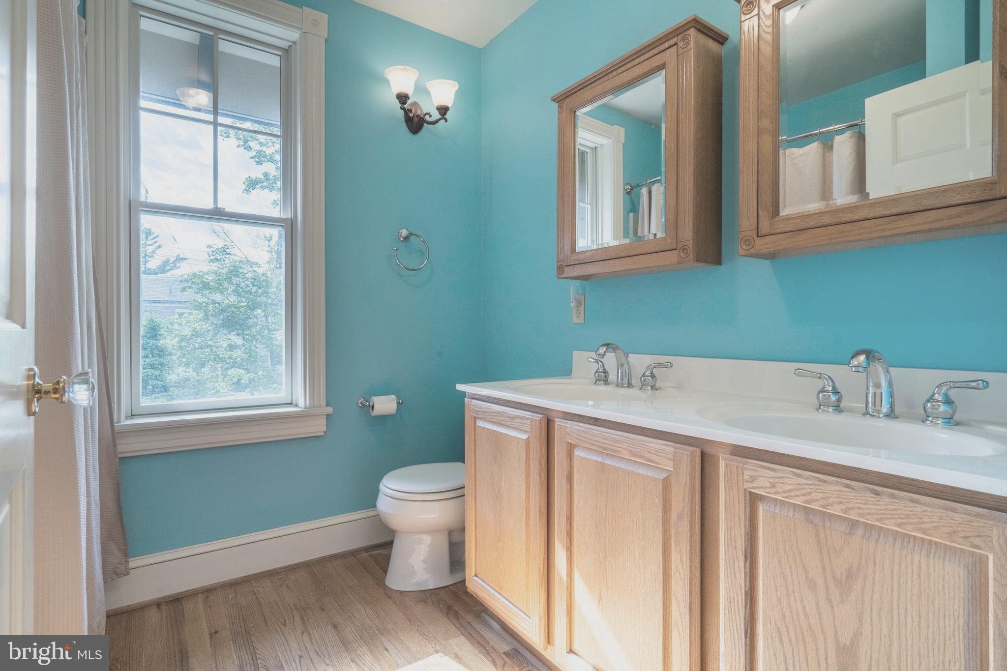 301 Midland Avenue Wayne, PA 19087 - Photo 37 of 63 a bathroom with a granite countertop sink toilet and mirror