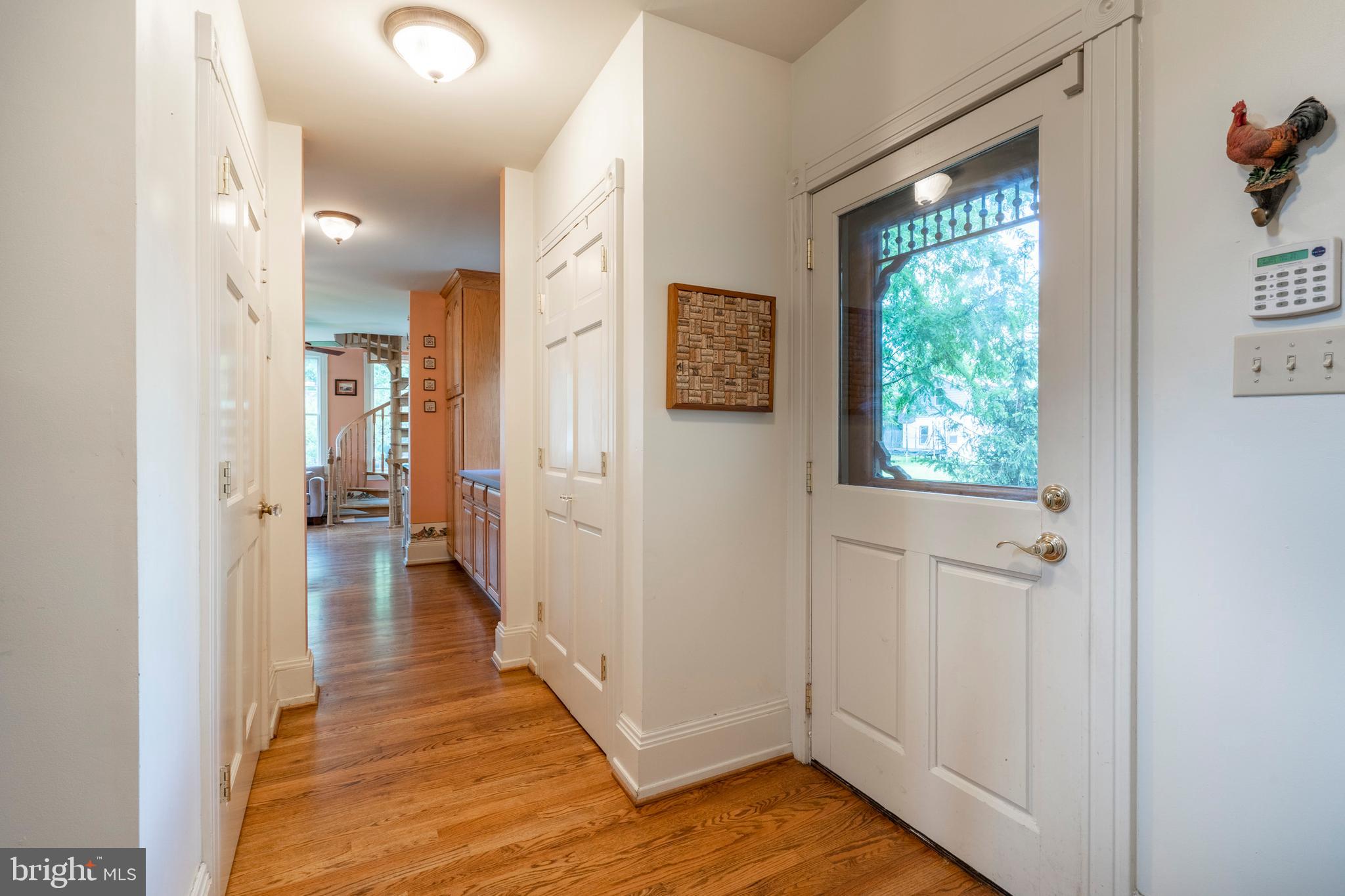 301 Midland Avenue Wayne, PA 19087 - Photo 46 of 63 a view of a hallway with wooden floor and a bathroom