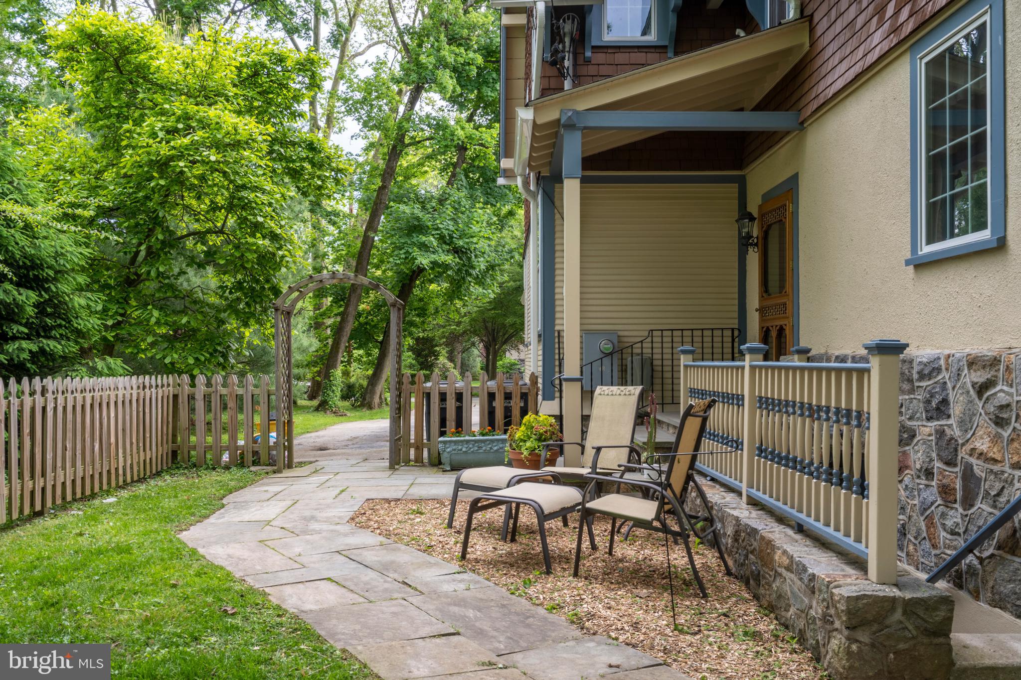 301 Midland Avenue Wayne, PA 19087 - Photo 49 of 63 a view of a patio with table and chairs with wooden fence and floor