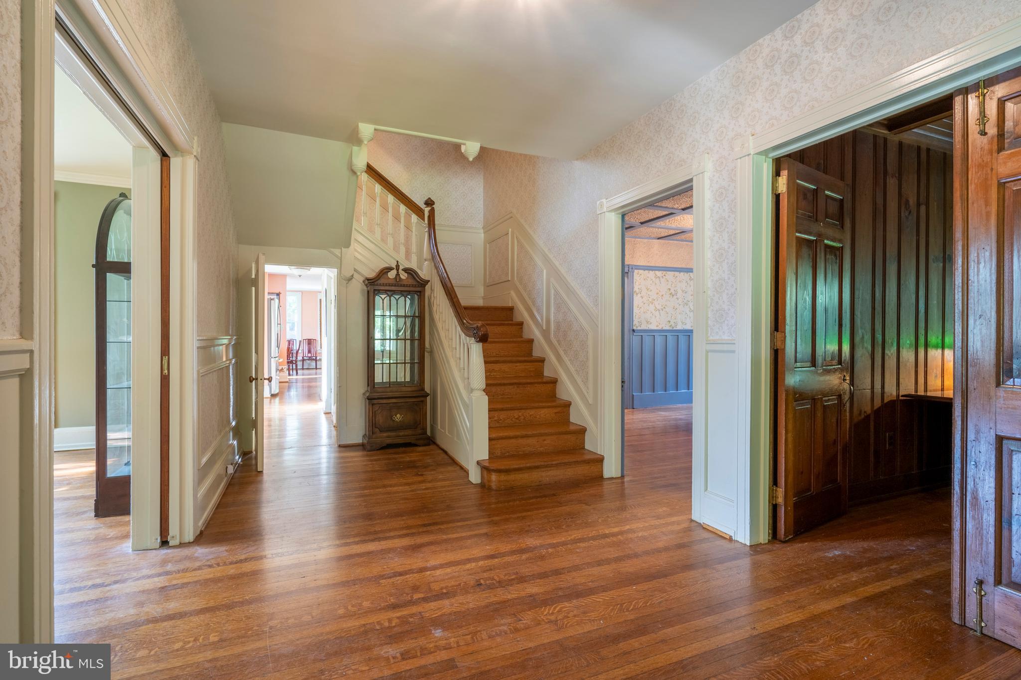 301 Midland Avenue Wayne, PA 19087 - Photo 7 of 63 a view of a hallway with wooden floor and staircase