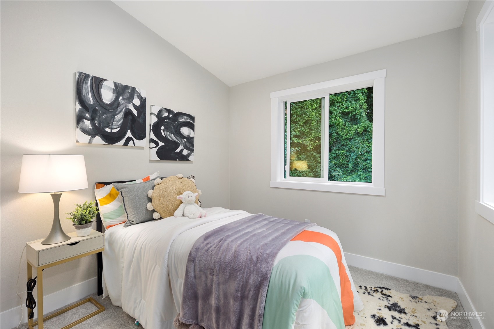 3303 31st Avenue Southwest, Unit B Seattle, WA 98126 - Photo 16 of 26 a bedroom with a bed and a lamp