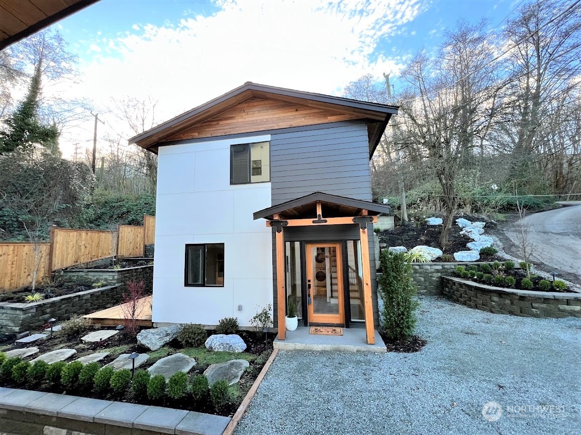3303 31st Avenue Southwest, Unit B Seattle, WA 98126 - Photo 2 of 26 a front view of a house with garden