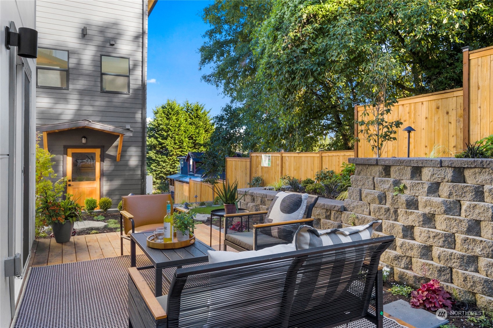 3303 31st Avenue Southwest, Unit B Seattle, WA 98126 - Photo 21 of 26 a view of a patio with table and chairs and potted plants