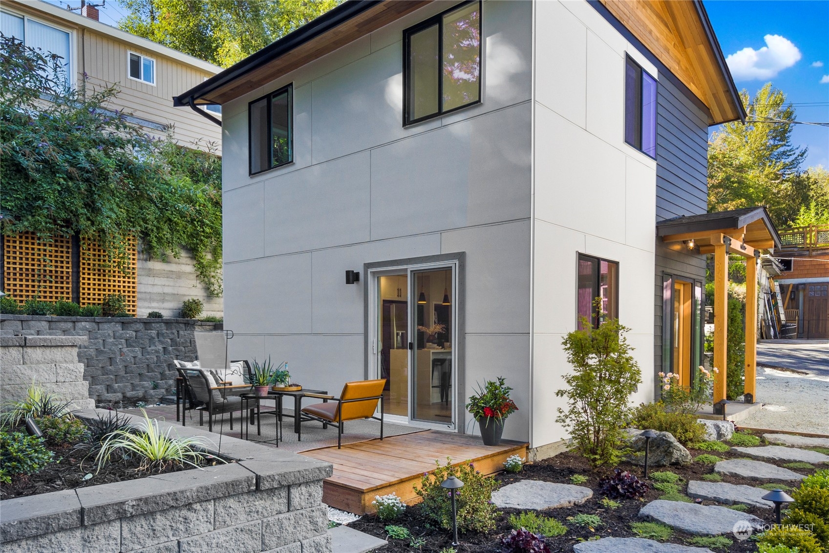 3303 31st Avenue Southwest, Unit B Seattle, WA 98126 - Photo 22 of 26 a view of a house with backyard and sitting area