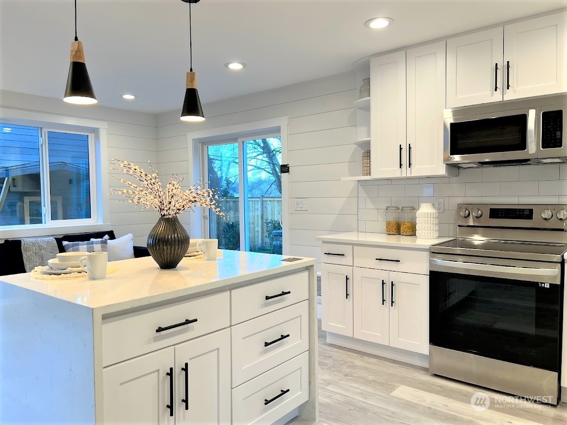 3303 31st Avenue Southwest, Unit B Seattle, WA 98126 - Photo 7 of 26 a kitchen with a sink stove and microwave