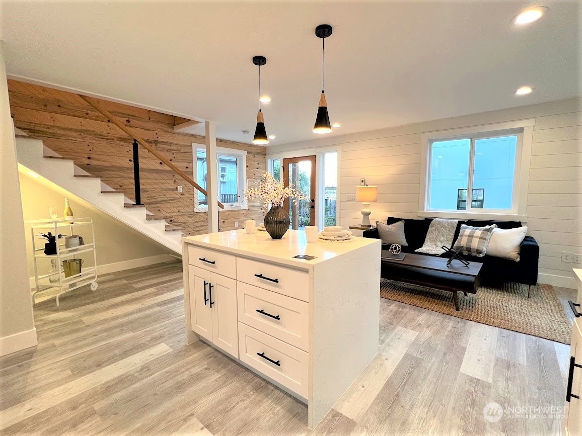 3303 31st Avenue Southwest, Unit B Seattle, WA 98126 - Photo 9 of 26 a living room with furniture and a chandelier