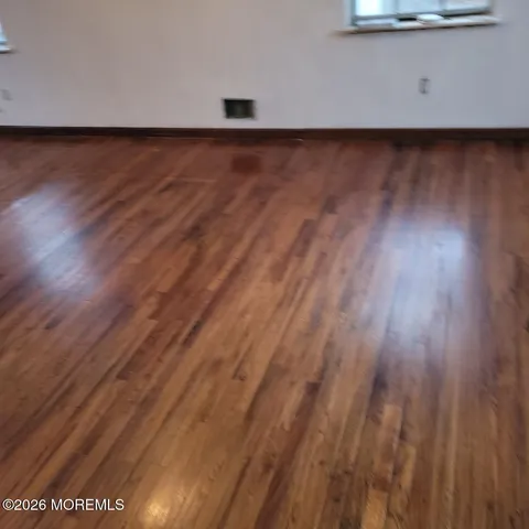 a view of a room with wooden floor