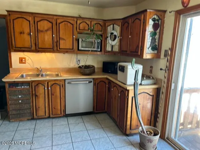 a view of a kitchen with fridge and washer