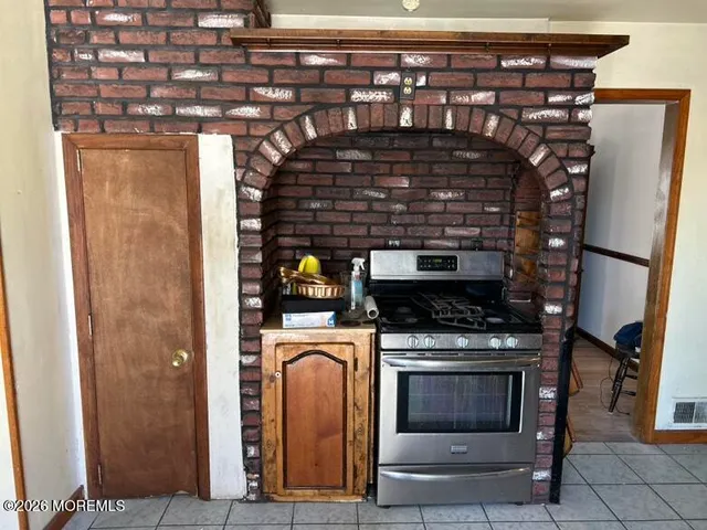 a stove top oven sitting inside of a kitchen