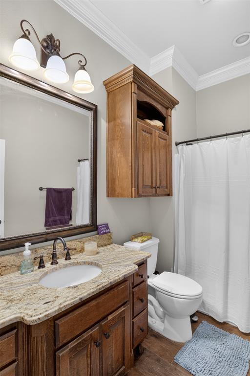 11868 Timber Ridge Drive Keithville, LA 71047 - Photo 19 of 37 Bathroom featuring a vanity with a granite countertop, undermount sink, and wood-finish cabinetry