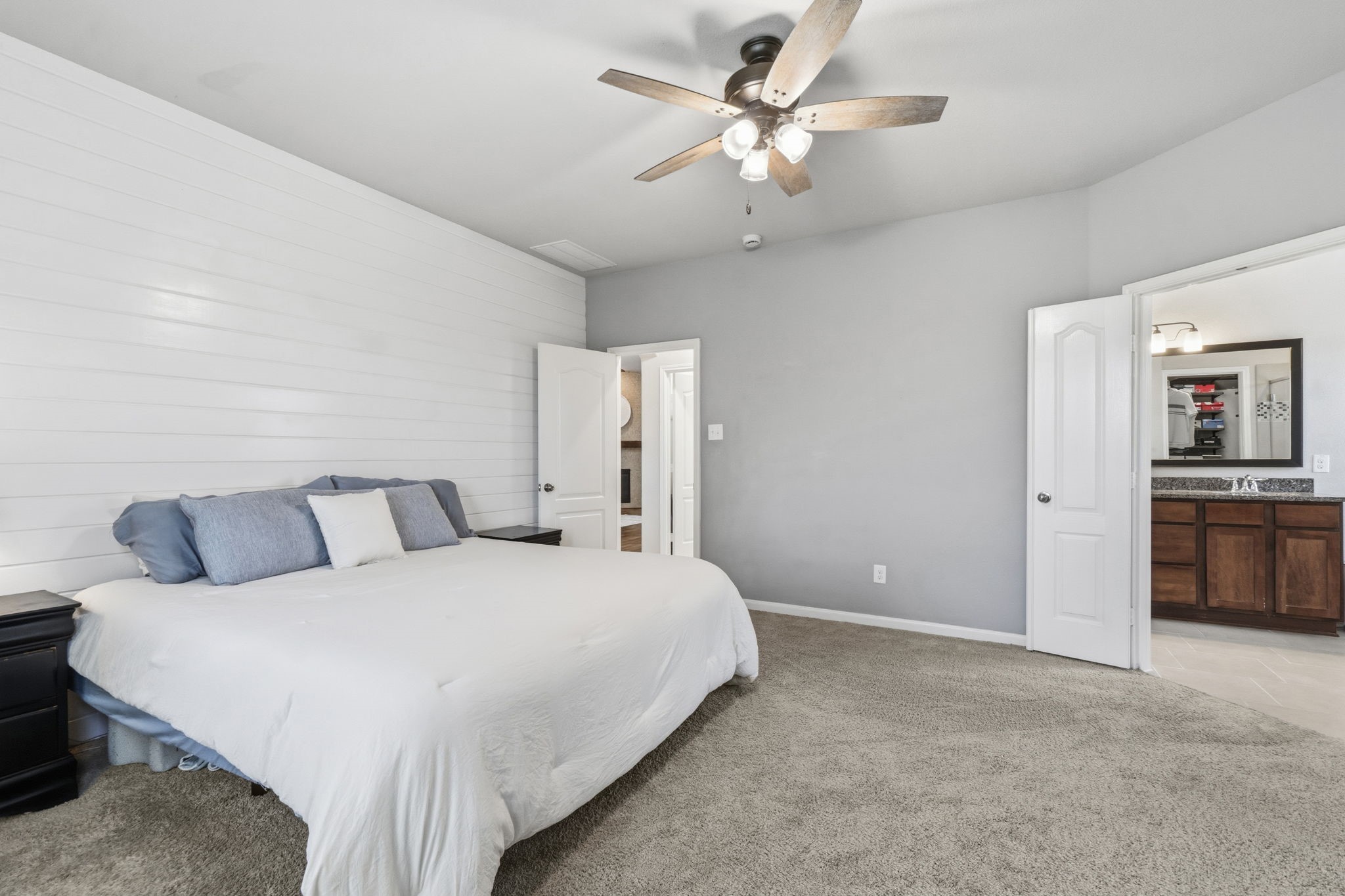 3900 Enchanted Timbers Lane Spring, TX 77386 - Photo 20 of 49 a spacious bedroom with a bed and a chandelier