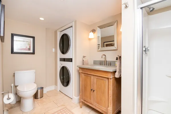 a bathroom with a toilet a sink and a mirror