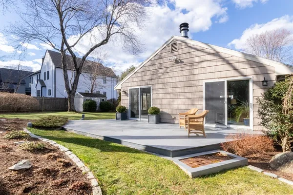 a view of a house with backyard and sitting area