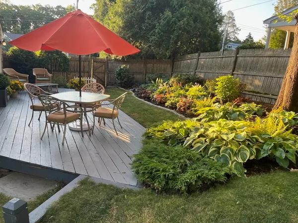 a backyard of a house with table and chairs
