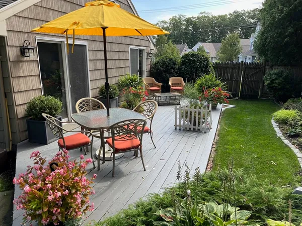 a backyard of a house with outdoor seating
