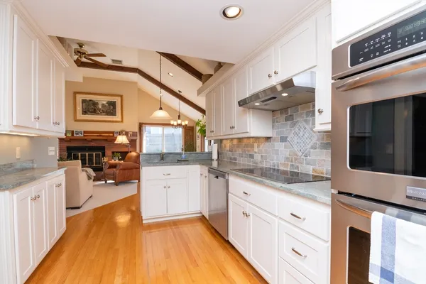 a kitchen with stainless steel appliances granite countertop a sink and cabinets