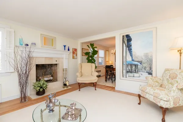 a living room with furniture a fireplace and a table