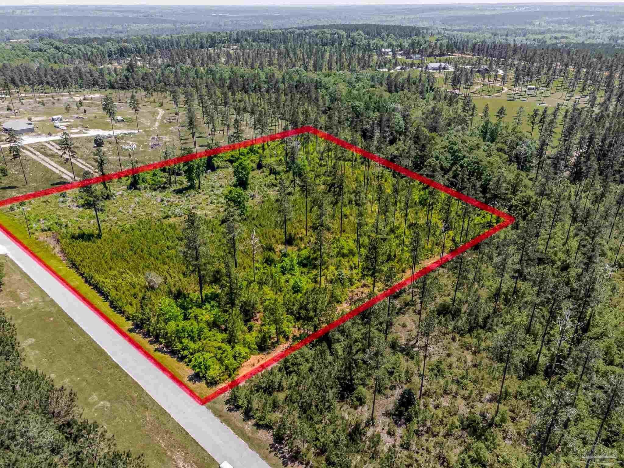 0 Allen Road Atmore, AL 36502 - Photo 3 of 29 a view of a lake with a flower garden and wooden bridge