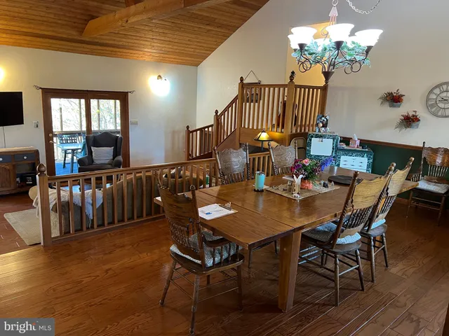 a dining room with furniture and wooden floor