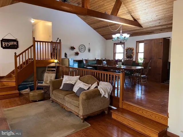 a living room with furniture a chandelier and a window