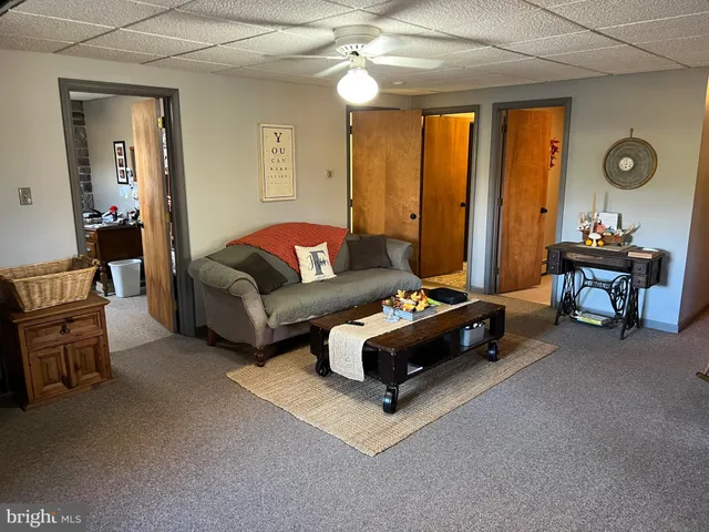 a living room with furniture a window and gym equipment