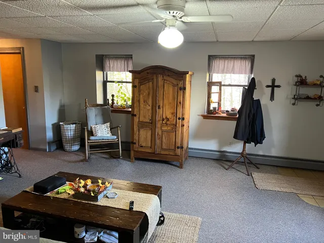a view of a livingroom with workspace and a couch