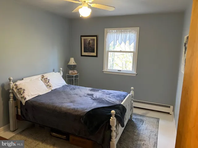 a bedroom with two beds and a flat screen tv