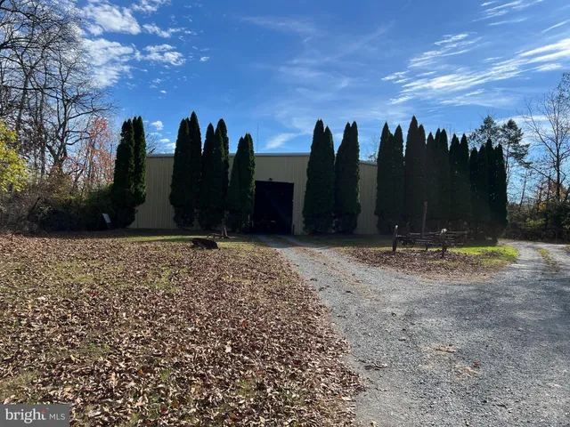 a backyard of a house with chairs