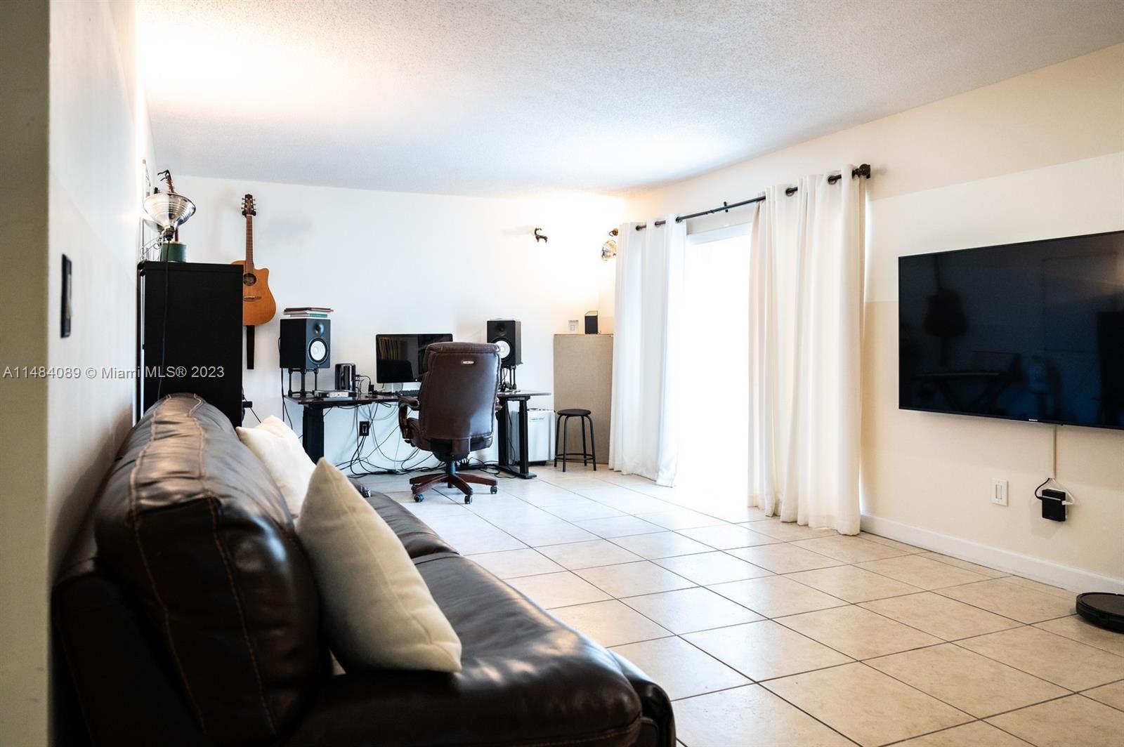 7715 Southwest 86th Street, Unit A2307 Miami, FL 33143 - Photo 12 of 89 a view of a livingroom with workspace and a window