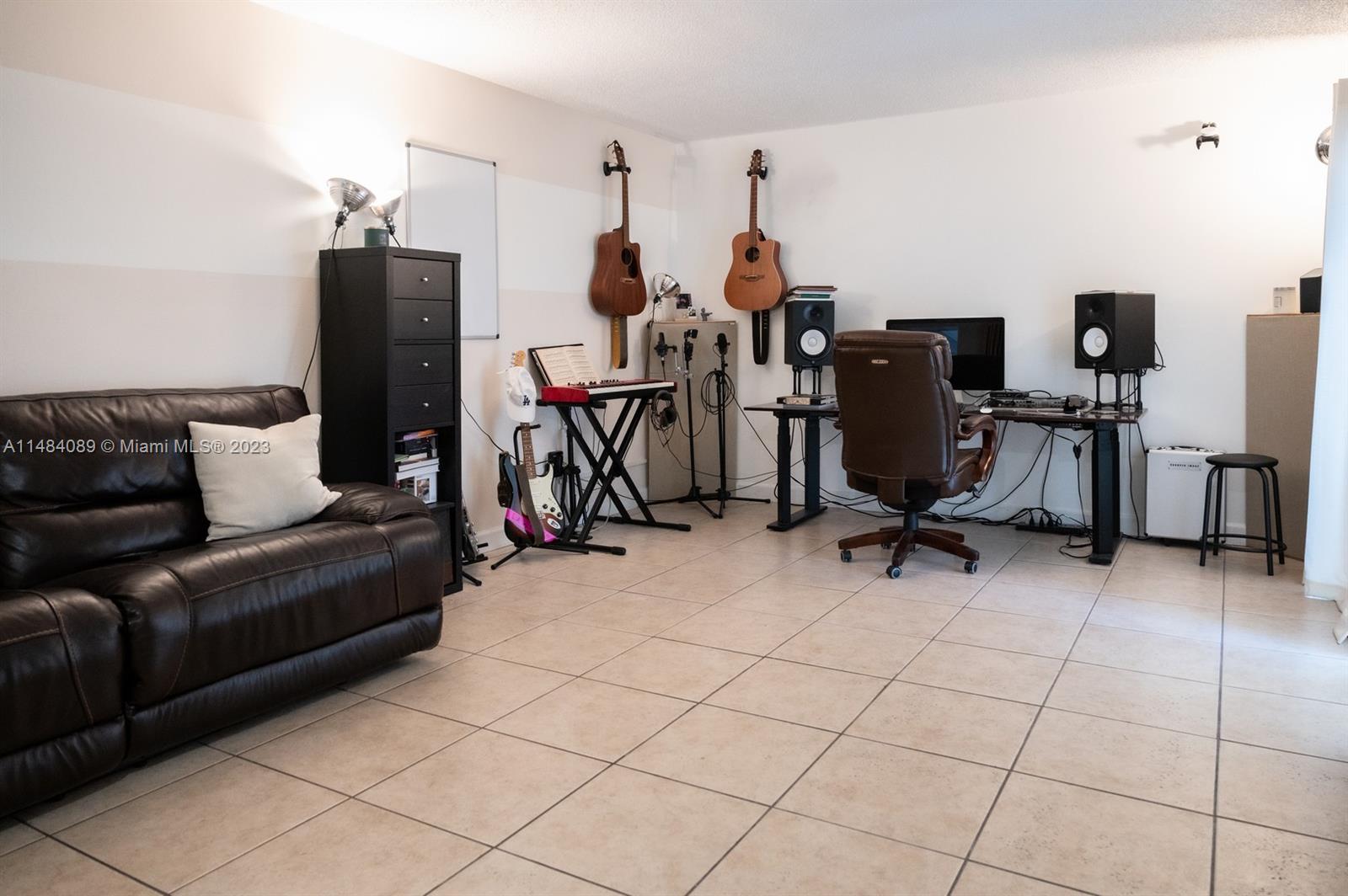 7715 Southwest 86th Street, Unit A2307 Miami, FL 33143 - Photo 15 of 89 a view of a livingroom with workspace and a couch